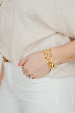 Gold cross bracelet stack